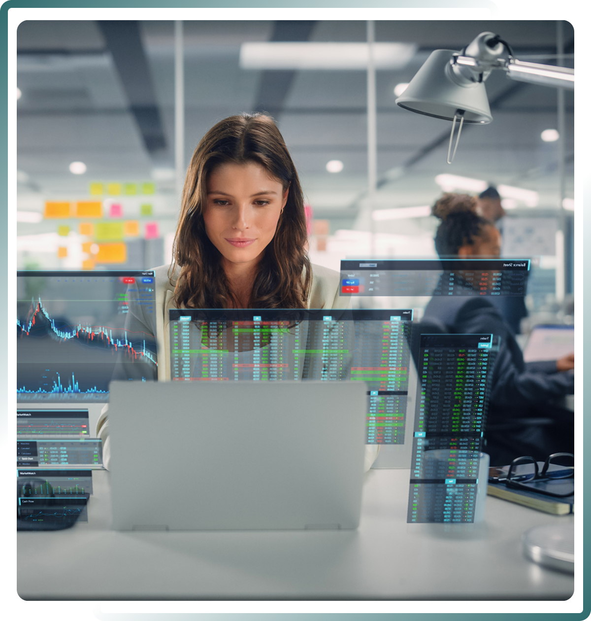 Woman analyzing data on laptop screens.