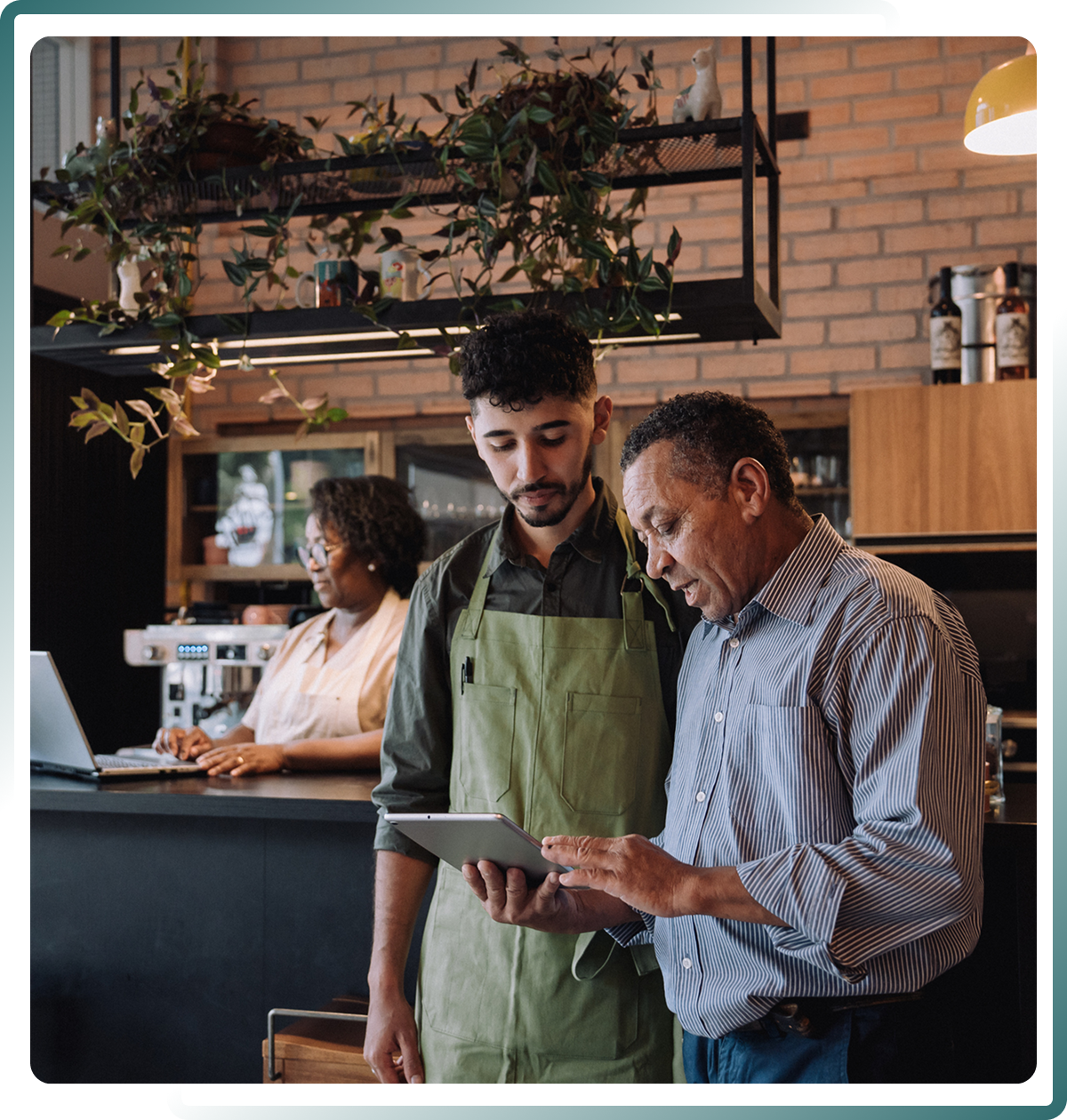 Barista and customer discussing tablet content.